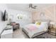 Bright bedroom showcasing geometric wall, ceiling fan, and comfortable seating area at 8738 E Rose Ln, Scottsdale, AZ 85250