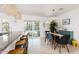 Bright dining area features pool views, modern lighting, breakfast bar and stylish decor at 8738 E Rose Ln, Scottsdale, AZ 85250