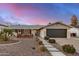 Charming single-story home boasting a well-manicured front yard, two-car garage, and inviting curb appeal at 8738 E Rose Ln, Scottsdale, AZ 85250