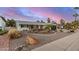 Well-maintained single-story home with a landscaped front yard and a circular driveway, showcasing its curb appeal at 8738 E Rose Ln, Scottsdale, AZ 85250