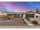 Charming single-story home with a landscaped front yard, a black two-car garage, and appealing curb appeal at 8738 E Rose Ln, Scottsdale, AZ 85250