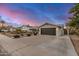Charming home featuring a spacious driveway, desert landscaping, and attached two-car garage at 8738 E Rose Ln, Scottsdale, AZ 85250
