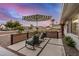 Inviting front porch showcasing cozy seating, stylish umbrella, and a relaxed outdoor ambiance at 8738 E Rose Ln, Scottsdale, AZ 85250