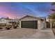 Exterior features include a spacious driveway, desert landscaping, and attached two-car garage at 8738 E Rose Ln, Scottsdale, AZ 85250