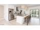 Modern kitchen features granite countertops, stainless steel appliances, and an island with bar seating at 8738 E Rose Ln, Scottsdale, AZ 85250