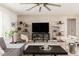 Stylish living room boasts textured walls, modern shelving, comfortable seating, and contemporary design at 8738 E Rose Ln, Scottsdale, AZ 85250