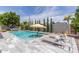 Refreshing backyard pool with a tanning ledge and elegant lounge chairs perfect for relaxation at 8738 E Rose Ln, Scottsdale, AZ 85250
