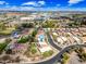 Aerial shot of a residential area featuring well-maintained homes with manicured lawns and a swimming pool at 9364 S Margo Dr, Tempe, AZ 85284