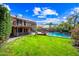 Expansive backyard with green lawn, mature trees, and a sparkling pool offers an ideal entertaining space at 9364 S Margo Dr, Tempe, AZ 85284