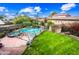 Aerial view of backyard featuring a pool, spa, and lush landscaping at 9364 S Margo Dr, Tempe, AZ 85284