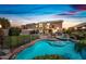 Backyard featuring a large pool, spa, and well-manicured lawn under a colorful sky at 9364 S Margo Dr, Tempe, AZ 85284