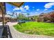 Lush backyard featuring green grass, beautiful flowers, and a sparkling pool provides a relaxing outdoor space at 9364 S Margo Dr, Tempe, AZ 85284
