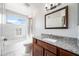 Bright bathroom with granite counters, white marble tile, and a shower-tub combo at 9364 S Margo Dr, Tempe, AZ 85284