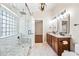 Bright bathroom featuring a glass shower, marble tiles, and wooden cabinets at 9364 S Margo Dr, Tempe, AZ 85284
