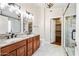 Stylish bathroom featuring dual sinks, granite countertops, and a glass-enclosed shower at 9364 S Margo Dr, Tempe, AZ 85284