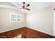 Bedroom with hardwood floors, ceiling fan, and a bright window with shutters at 9364 S Margo Dr, Tempe, AZ 85284
