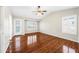 Bright bedroom with hardwood floors, vaulted ceilings, a ceiling fan, and large windows at 9364 S Margo Dr, Tempe, AZ 85284