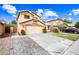 Two-story home showcasing its well-kept lawn, paver walkway, neutral color scheme and attached garage at 9364 S Margo Dr, Tempe, AZ 85284