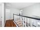 Upstairs hallway featuring wood floors, a staircase, and a closet offering functionality at 9364 S Margo Dr, Tempe, AZ 85284