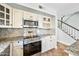 Well-equipped kitchen with stainless steel appliances and a staircase nearby at 9364 S Margo Dr, Tempe, AZ 85284