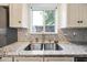 Close-up of the kitchen sink featuring granite countertops and modern fixtures at 9364 S Margo Dr, Tempe, AZ 85284