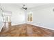 Bright and airy living room featuring tile floors, a ceiling fan, and a large window with plantation shutters at 9364 S Margo Dr, Tempe, AZ 85284