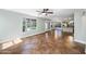 Open living space featuring ceramic tile flooring, ceiling fan, and large windows for natural light at 9364 S Margo Dr, Tempe, AZ 85284