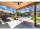 Covered patio overlooking a fenced-in pool with lush greenery, ideal for outdoor relaxation at 9364 S Margo Dr, Tempe, AZ 85284