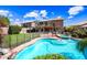 The backyard contains a pool, spa, plants, trees, rocks, desert landscaping and a two-story home at 9364 S Margo Dr, Tempe, AZ 85284