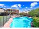 The backyard contains a pool, spa, plants, trees, desert landscaping and a two-story home at 9364 S Margo Dr, Tempe, AZ 85284