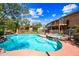 A sparkling pool and spa in a backyard with a two-story house in the background at 9364 S Margo Dr, Tempe, AZ 85284