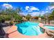 A fenced in pool and spa are the focal point in a backyard with lots of green foliage and trees at 9364 S Margo Dr, Tempe, AZ 85284