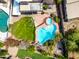 Aerial view of a backyard with a large swimming pool, jacuzzi, and lush green landscaping at 9364 S Margo Dr, Tempe, AZ 85284