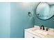 Stylish powder room featuring a marble vanity and a round mirror with unique details at 9364 S Margo Dr, Tempe, AZ 85284