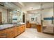This bathroom features double sinks, granite counters, custom cabinetry, and a glass enclosed shower at 9722 E Mark Ln, Scottsdale, AZ 85262