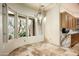 The dining area features natural light, views of the desert landscape, and tile flooring at 9722 E Mark Ln, Scottsdale, AZ 85262