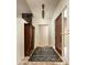 The entryway has tile floors, a patterned rug, a storage cabinet and contemporary lighting at 9722 E Mark Ln, Scottsdale, AZ 85262