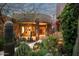 Desert home with stone accents and lush landscaping, offering a unique and inviting entrance at 9722 E Mark Ln, Scottsdale, AZ 85262