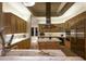 Modern kitchen with custom wood cabinets, marble countertops, and stainless steel appliances at 9722 E Mark Ln, Scottsdale, AZ 85262