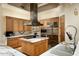 Well-appointed kitchen featuring custom cabinets, granite countertops, and stainless steel appliances at 9722 E Mark Ln, Scottsdale, AZ 85262