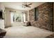 A spacious living room offers natural light, stone accents, and desert views at 9722 E Mark Ln, Scottsdale, AZ 85262