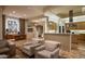 Open-concept living room with travertine floors, comfortable seating, and seamless flow into the kitchen at 9722 E Mark Ln, Scottsdale, AZ 85262