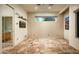 Open living area with tiled floors, large window and media center area at 9722 E Mark Ln, Scottsdale, AZ 85262