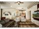 Open-concept living room with access to kitchen, comfortable seating, and natural lighting at 9722 E Mark Ln, Scottsdale, AZ 85262