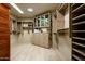 This spacious walk-in closet provides ample storage with custom shelving and drawers at 9722 E Mark Ln, Scottsdale, AZ 85262