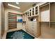 This walk-in closet offers ample storage with custom shelves, drawers, and cabinets at 9722 E Mark Ln, Scottsdale, AZ 85262