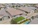 Aerial view showcasing the home's backyard, landscaped lawn, patio, and refreshing pool at 12351 W Palmaire Ave, Glendale, AZ 85307