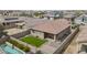 Aerial view showcasing the home's backyard, landscaped lawn, patio, and refreshing pool at 12351 W Palmaire Ave, Glendale, AZ 85307