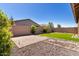 Large backyard with artificial turf, rock landscape, and paver patio at 12351 W Palmaire Ave, Glendale, AZ 85307