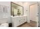 Bathroom featuring large mirror, dual sinks, spacious vanity with modern cabinets, and wood-style floors at 12351 W Palmaire Ave, Glendale, AZ 85307